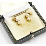 A pair of 9ct gold double scroll earrings, each set with two cultured pearls on single pin back, lac
