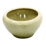 A Moorcroft pottery bowl, in a pale green glaze decorated with a raised band of vertical markings, i