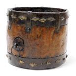 A Continental wooden and iron bound container, of cylindrical form with applied lozenge shaped motif