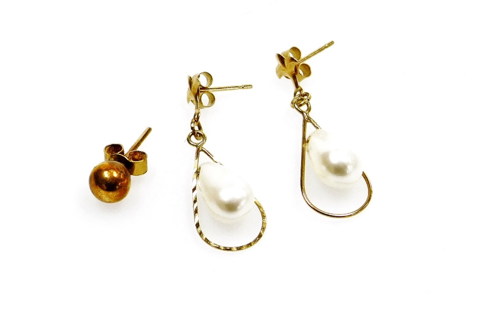 A pair of 9ct gold cultured pearl drop earrings, each pearl in a basket setting with fleur de lys to