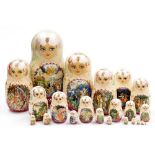 A Matryoshka graduated set of twenty two nesting dolls, painted with reserves of myths and legends,
