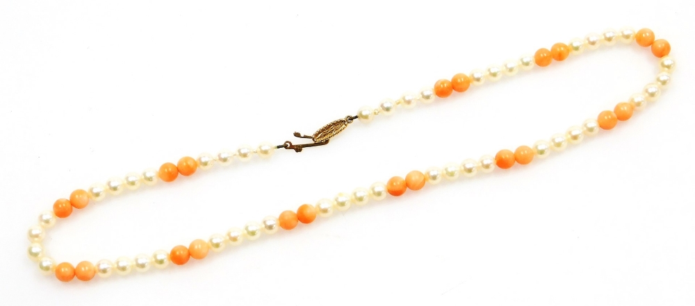 A coral and cultured pearl necklace, on a knotted string strand with a 9ct gold clasp, 38cm long, 15