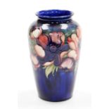 A Moorcroft pottery vase decorated in the Anemone pattern, against a cobalt blue ground, impressed a