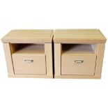 A pair of light oak bedside chests, with a recess over a drawer, raised on a plinth base, 56cm high,