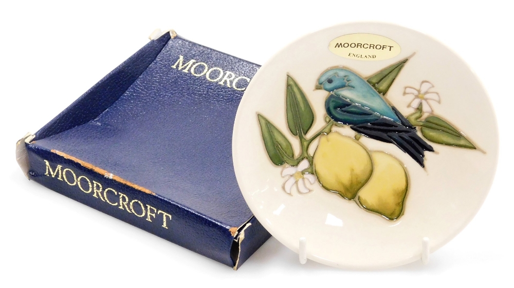 A Moorcroft pottery pin dish, of circular form, decorated with lemons and a bird, designed by Sally