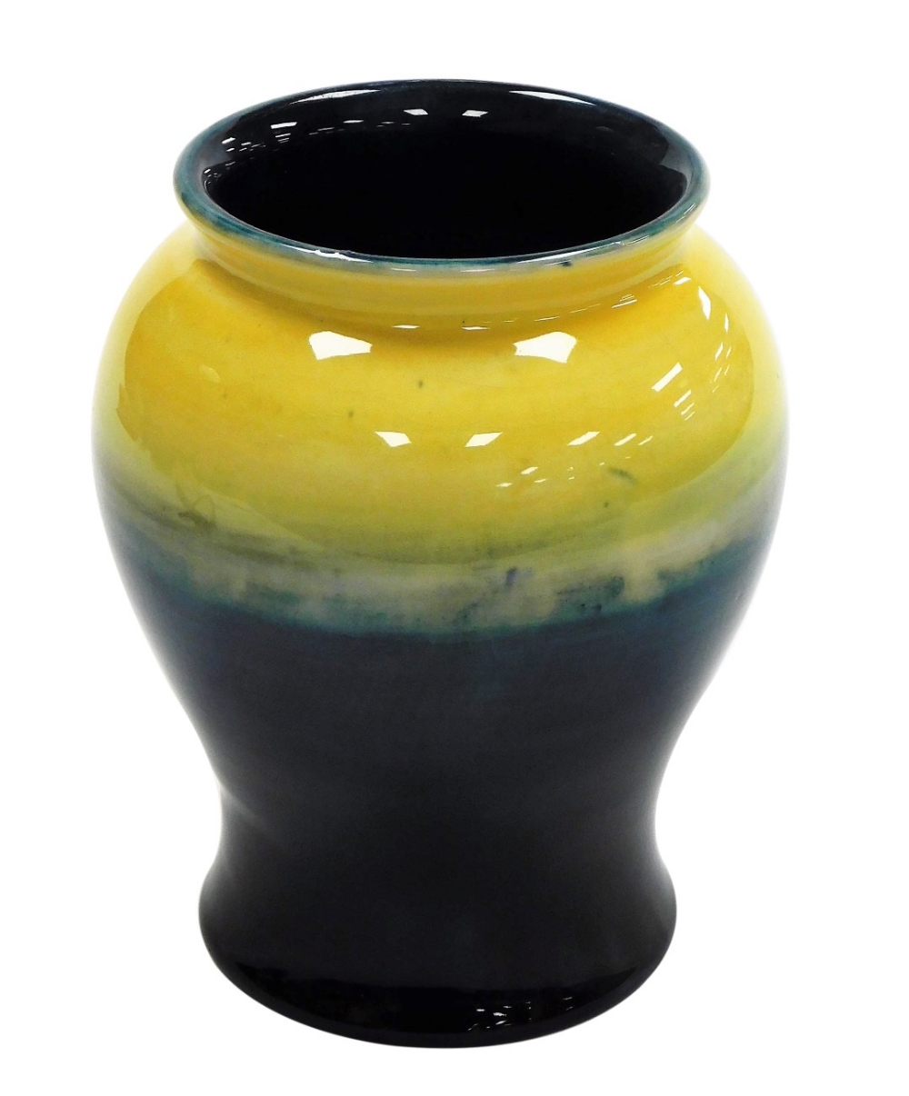 A Moorcroft pottery vase, of baluster form, in graduated yellow and blue glaze, impressed marks and