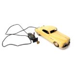 An Arnold American mid century primal tin plate pump action remote control motorcar.