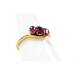 An amethyst twist ring, set with three oval amethysts in claw setting with twist detailing, yellow m