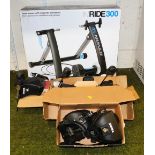An In'ride 300 home trainer with magnetic resistance, boxed, and various Thule roof rack feet, 753 a