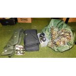 Two fabric gun cases, shooting targets, pellets, and other shooting related items.