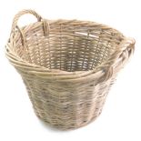 A wicker log basket, with fixed handles of tapering cylindrical form, 44cm high.