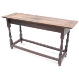 An oak low table, the rectangular top with a carved border on turned supports and plain