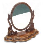 A Victorian figured mahogany dressing table mirror, the oval plate on carved supports, the