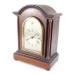 An Edwardian mahogany table clock, in arched case, the 12cm wide silvered etched Roman Numeric