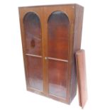 A mahogany bookcase, with two glazed doors enclosing shelves, 165cm x 102cm. (AF)