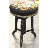 A Victorian ebonised and parcel gilt adjustable piano stool, the circular top decorated with