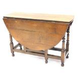 A 19thC oak D-end drop leaf gate leg table, on turned legs, some parts perhaps 18thC, when closed