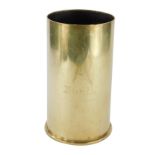 A brass Falklands trench art shell case bottle coaster, partially etched with a map of Europe,