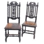 A pair of Victorian ebonised oak side chairs, in Carolean style each with a padded seat on