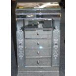 A mirror finish jewellery box, with two tier lifting top, above arrangement of four drawers, with tw