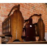A pair of oak magazine racks, together with a mahogany magazine rack. (3)