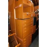 A Schrieber teak effect bedroom suite, comprising continental headboard, two chests of drawers, otto