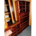 A mahogany effect five piece bedroom, to include chest of drawers, two bedsides, dressing table and