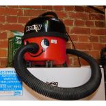 A Henry vacuum cleaner, with bags and hoses.