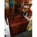 A late Victorian walnut dressing chest, with swing mirror.