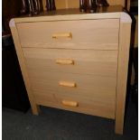 An oak effect chest of four drawers.