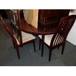 A drop leaf dining table, together with four chairs. The upholstery in this lot does not comply with