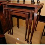 A mahogany nest of tables, with leather inserts.