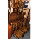 A set of six stained beech wheel back dining chairs.