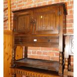 A linen fold carved oak side cupboard, with single drawer.