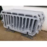 Eleven sections of plastic construction fencing dividers.