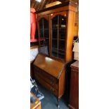 A 1920's mahogany bureau bookcase, raised on cabriole legs.