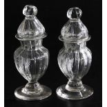 A pair of late 17th/early 18thC glass jars and covers, of baluster design with flared rims and flute