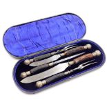 A Victorian carving set, comprising two pairs of forks and knives, the blades stamped James Deakin a