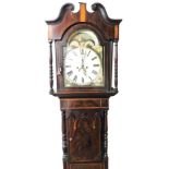 An early 19thC flame mahogany and boxwood inlaid longcase clock, the moon phase arched dial painted