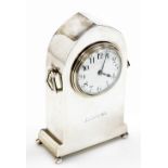 An early 20thC silver cased mantel clock, in a plain lancet shaped case, with two ring handles, the