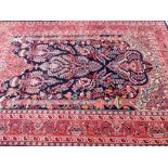 An Iranian carpet, with an outer field of floral geometric pattern, predominantly in red and blue, 2