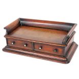 A 19thC mahogany desk stand, with a three quarter raised gallery above two drawers, each with ebonis