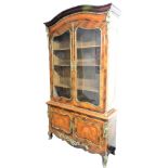 A Louis XV style rosewood bibliotheque, the domed top above a floral marquetry frieze, over a pair o