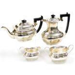 A George V silver four piece tea set, in the Georgian style, comprising teapot, hot water jug, cream