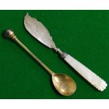 A silver gilt commemorative spoon, and a butter knife with mother of pearl handle.