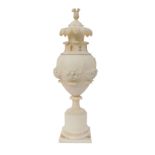 A carved alabaster urn and cover, with carved relief floral basket panels and raised leaves, with co