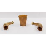 A horn beaker, 9cm high, and two horn blotters, each with a brass cap end. (3)
