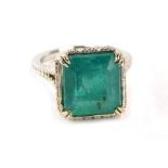 An emerald and diamond dress ring, with octagonal step cut emerald, measuring 12.10 x 11.11 x 8.77mm