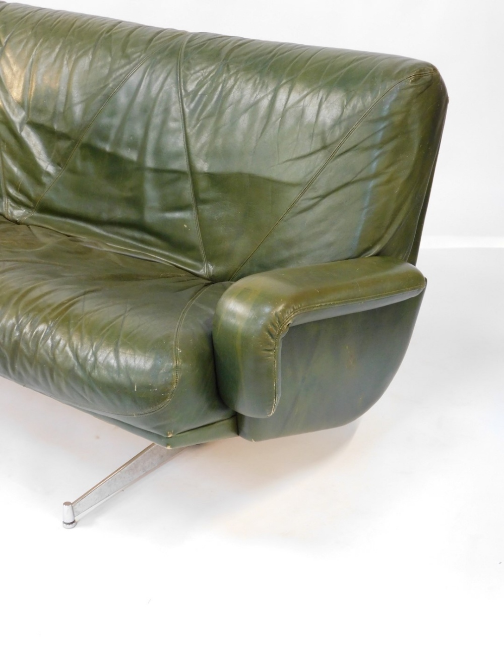 A 1960's vintage green leather three seater sofa, raised on twin chrome plated and cast iron support - Image 2 of 4