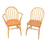 Two Ercol pine stick back kitchen chairs, to include one carver.